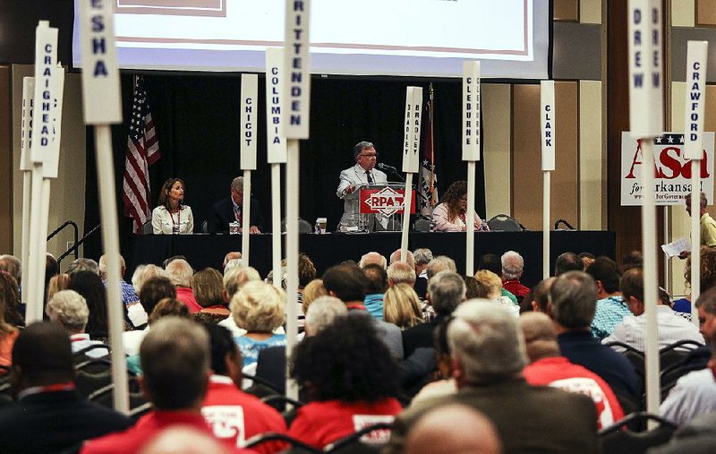 In this 2018 file photo Doyle Webb (center), chairman of the Arkansas Republican Party, speaks during the party’s state convention. 
