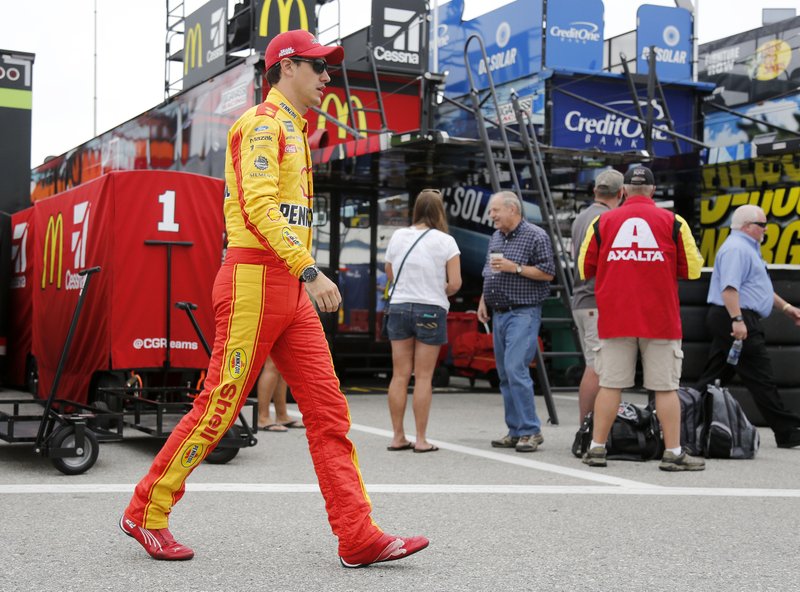 Joey Logano walks to his car in the garage at the start of practice for the NASCAR Cup Series auto race Saturday, July 21, 2018, at New Hampshire Motor Speedway in Loudon, N.H. (AP Photo/Mary Schwalm)
