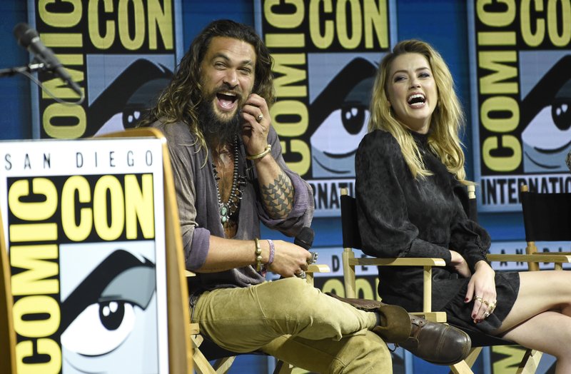 Jason Momoa, left, and Amber Heard attend the Warner Bros. Theatrical panel for &quot;Aquaman&quot; on day three of Comic-Con International on Saturday, July 21, 2018, in San Diego. (Photo by Chris Pizzello/Invision/AP)