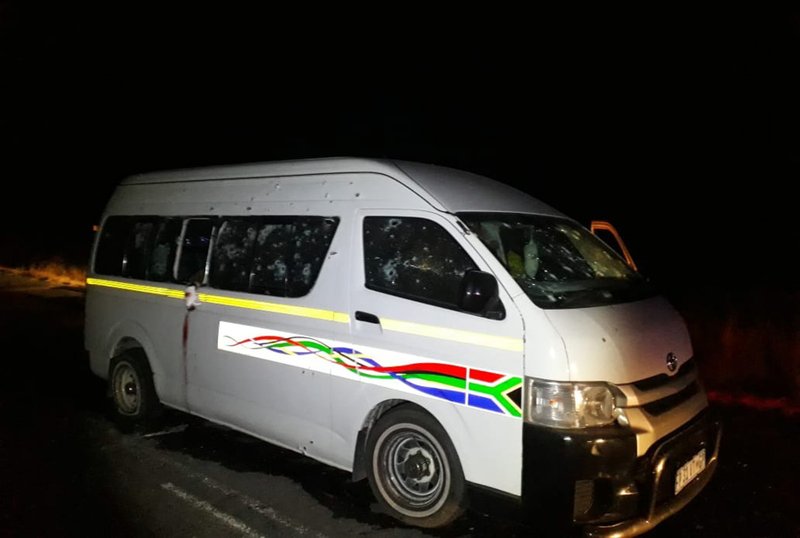 A minibus with bullet holes on its side is seen on the road between Weenen and Colenso, in KwaZulu Natal province, South Africa, early Sunday, July 22, 2018. South African police say gunmen opened fire Saturday night on the vehicle carrying members of a taxi drivers' association, killing 11 people and critically wounding four others. (Claudine Senegal/Ladysmith Herald via AP)