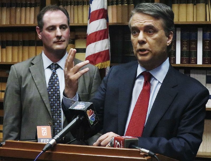 Kansas Gov. Jeff Colyer (right) answers a question from reporters with Lt. Gov. Tracey Mann (left) during a news conference in Topeka, Kan. Colyer in February issued an executive order that requires his staff to use official email accounts for all government business.  