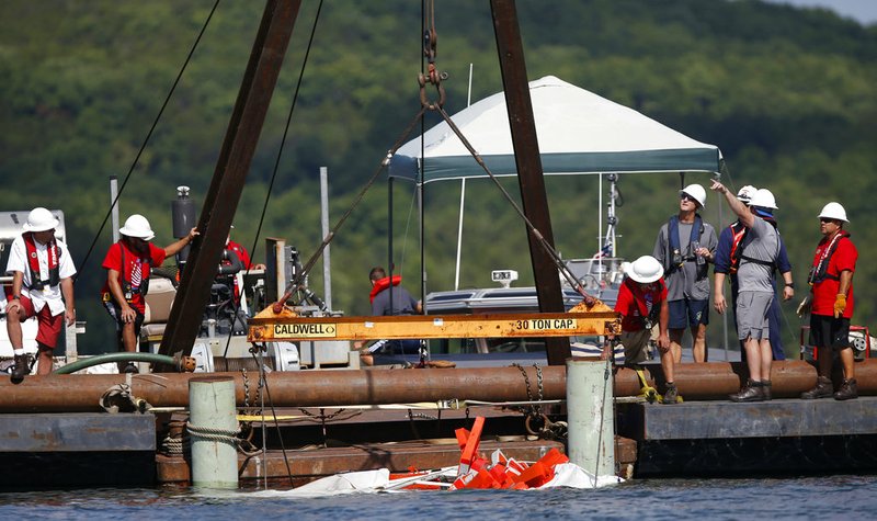 The duck boat that sank in Table Rock Lake in Branson, Mo., is raised Monday, July 23, 2018. 
