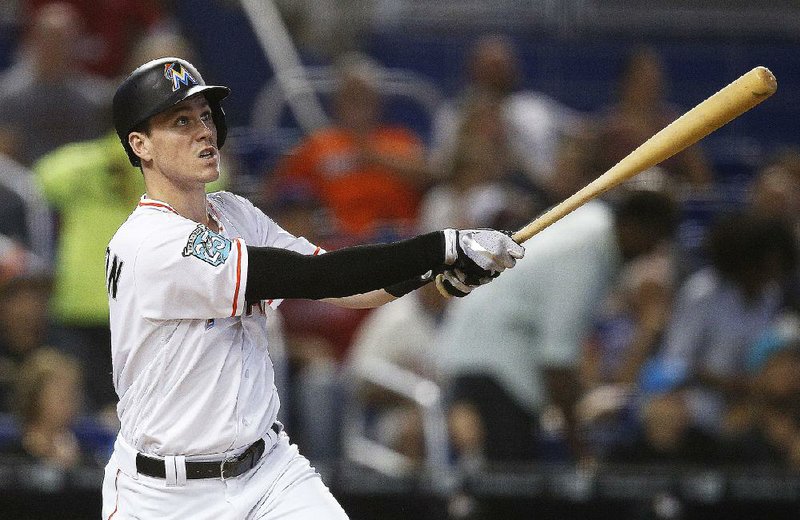 In this July 15, 2018, file photo, Miami Marlins' Brian Anderson hits a three-run home run during the fifth inning of a baseball game against the Philadelphia Phillies, in Miami. 