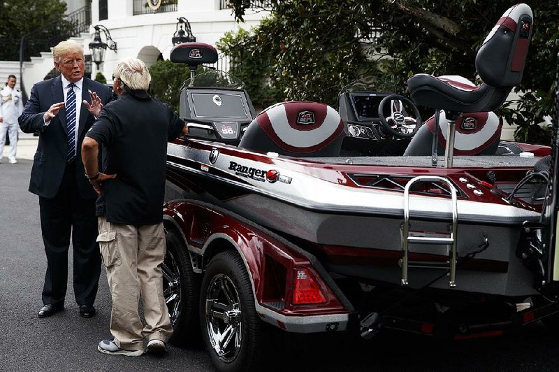 President Donald Trump talks with Jimmy Houston of Flippin-based Ranger Boats as he participates Monday in a tour during a Made in America Product Showcase at the White House. 