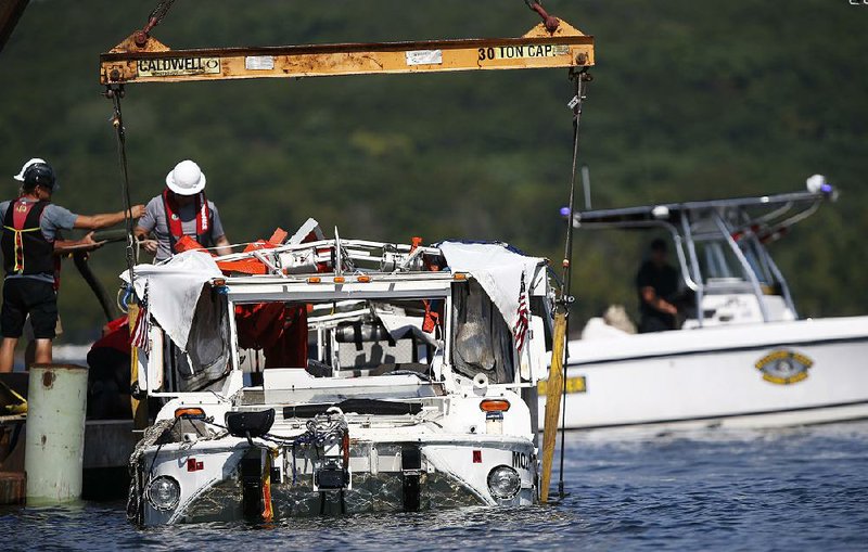 The duck boat that sank in Table Rock Lake in Branson is raised Monday. 