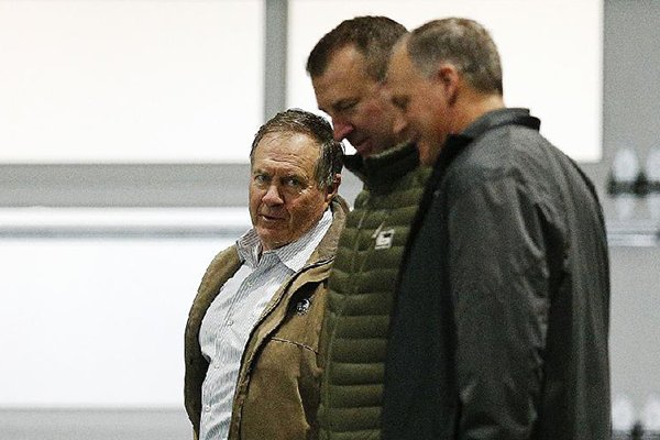 New England Patriots Coach Bill Belichick (left) and former Arkansas Coach Bret Bielema (center) walk the field during Alabama’s Pro Day on March 7 in Tuscaloosa, Ala. According to ESPN’s Field Yates, Bielema continues to work for the Patriots organization and is expected to be involved in coaching duties as well. (AP Photo/Brynn Anderson)