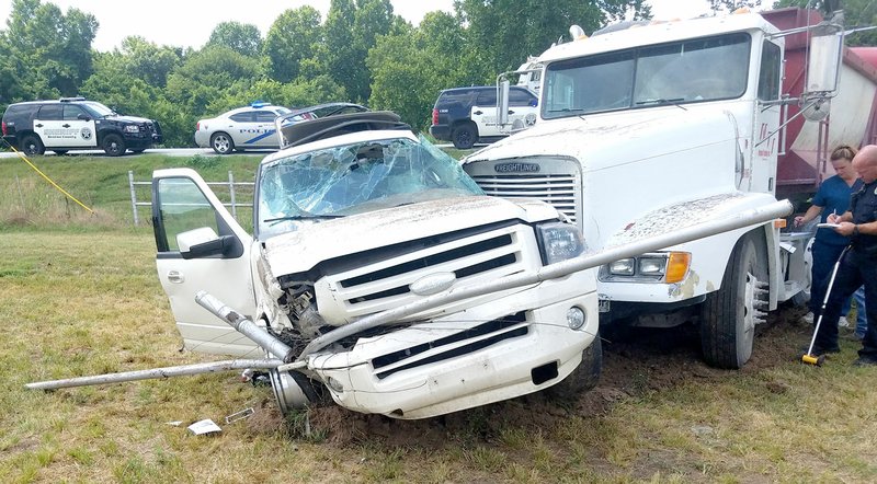 Westside Eagle Observer/SUBMITTED Parts of a metal fence are attached to the front of a sport-utility vehicle that was struck by a gravel truck at the corner of Crystal Lake Road and Highway 59 near Decatur on July 9. The driver of the SUV was transported to the hospital in Siloam Springs with a possible broken rib.