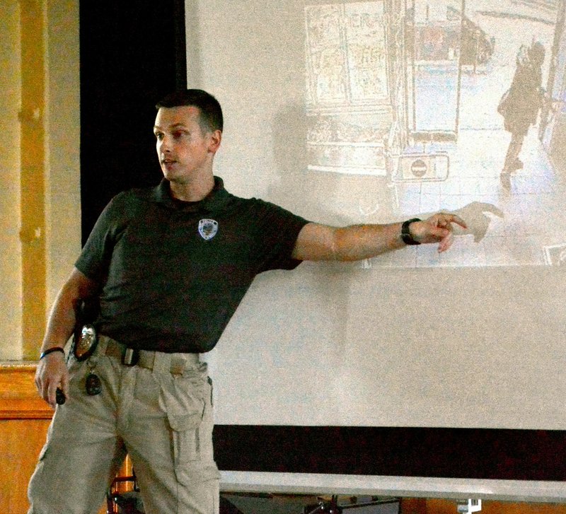 Janelle Jessen/Herald-Leader Officer Josh Fritz of the Siloam Springs Police Department led an active shooter training for local businesses at the Community Building on Monday night.