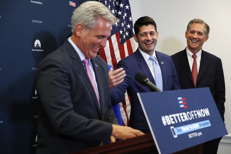 House Speaker Paul Ryan of Wis., center, jokes with House Majority Leader Kevin McCarthy of Calif., left, during a news conference following a GOP caucus meeting, Tuesday, July 24, 2018, on Capitol Hill in Washington. At right is Rep. French Hill, R-Arkansas. (AP Photo/Jacquelyn Martin)