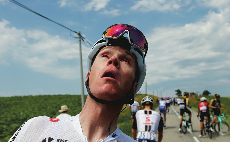 The Associated Press TEAR GAS TREATMENT: Britain's Chris Froome grimaces after being treated for tear gas or pepper spray sprayed on the peloton when a farmer's protest interrupted during the sixteenth stage of the Tour de France cycling race over 218 kilometers (135.5 miles) with start in Carcassonne and finish in Bagneres-de-Luchon, France, , Tuesday.