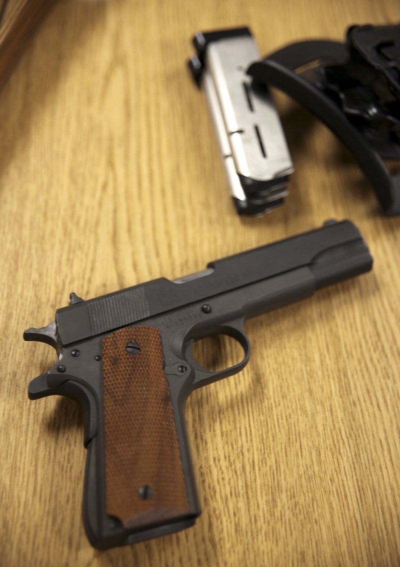 This May 10, 2016, file photo, shows a handgun sitting on a desk in the Hawaii Department of Natural Resources hunter education classroom in Honolulu.  The 9th U.S. Circuit Court of Appeals ruled Tuesday, July 24, 2018, that Hawaiian officials had violated George Young's rights by denying him a permit to openly carry a loaded gun in public.(AP Photo/Marina Riker, File)