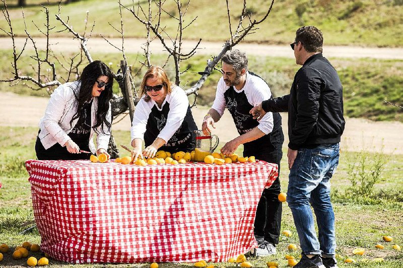 Host Tyler Florence checks on team Buns N’ Thighs, (from left) Victoria Elena Nones, Marla Nones and Ian M. Sherwin, on tonight’s episode of Food Network’s The Great Food Truck Race. 
