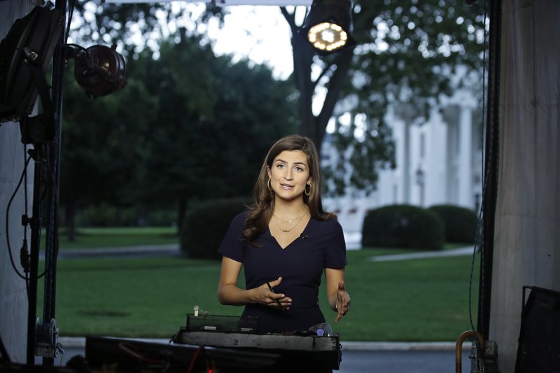 CNN White House correspondent Kaitlan Collins talks during a live shot in front of the White House, Wednesday, July 25, 2018, in Washington. Collins says the White House denied her access to President Donald Trump's Rose Garden statement with the European Union Commission president because officials found her earlier questions "inappropriate." (AP Photo/Alex Brandon)

