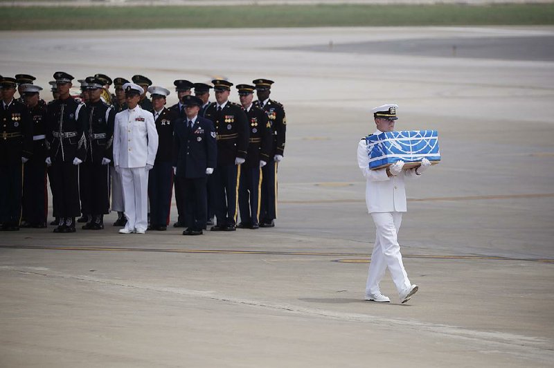 A U.S. serviceman carries a box containing the remains of a U.S. soldier, who was killed in the Korean War, during a ceremony today at Osan Air Base in Pyeongtaek, South Korea, after the remains of about 50 U.S. servicemen were flown out of North Korea on a U.S. transport plane. 