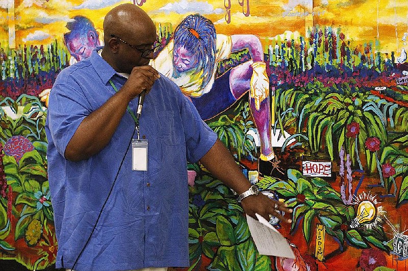 Arkansas Democrat-Gazette/THOMAS METTHE -- 7/26/2018 --
Artist Rex Deloney explains how he came up with the idea and vision for his mural from talking to P.A.R.K. graduates during the unveiling ceremony for the Class of 2018 mural on Thursday, July 26, 2018, at P.A.R.K. in Little Rock. Deloney said he started working on the mural in June and guesses he put in about 80 hours of work.