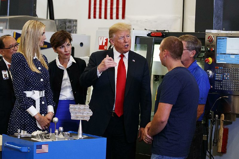 President Donald Trump tours an advanced manufacturing lab Thursday with Ivanka Trump (from left) and Iowa Gov. Kim Reynolds at Northeast Iowa Community College in Peosta, Iowa.