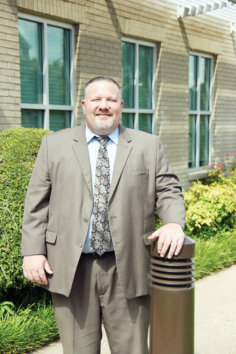 Jason Teague, the new police chief for the Sheridan Police Department, stands outside the Arkansas Insurance Department in Little Rock. He has served as a criminal investigator for the past year and a half but was recently hired as the police chief. He will begin work in the position on Monday. 