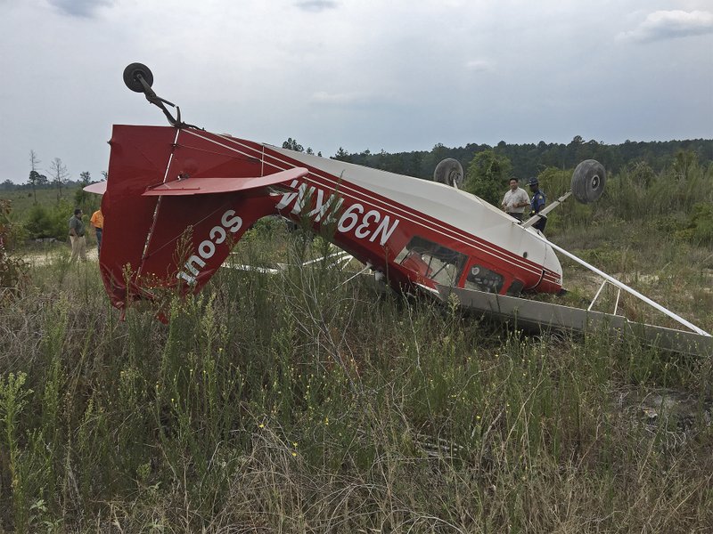 Crash: A single engine plane is shown overturned Friday after it crashed near Three Creeks and left two men with minor injuries.