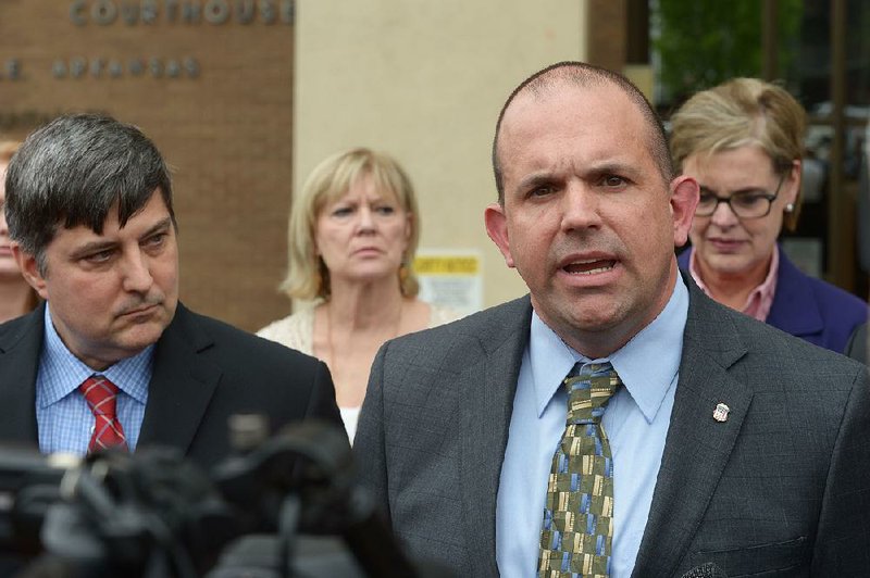 Duane (DAK) Kees (right), the U.S. Attorney for the Western District of Arkansas, speaks Thursday, May 3, 2018, alongside Kenneth Elser (left), assistant U.S. Attorney, and other members of the government's legal team and other government agencies outside the John Paul Hammerschmidt Federal Building in Fayetteville.