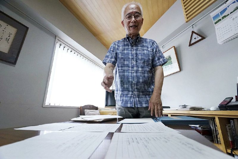 Bookstore owner Takeo Hatano displays the “Yuzawa memo” that he discovered nine years ago but kept secret until now “as I was afraid of a backlash” over its contents. 