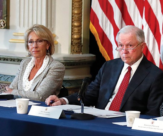 The Associated Press SAFETY COMMISSION: Education Secretary Betsy DeVos, left, and U.S. Attorney General Jeff Sessions listen to Francisco M. Negrón Jr., Chief Legal Officer of the National School Boards Association, during a meeting of the Federal Commission on School Safety on Thursday in the Indian Treaty Room of the Eisenhower Executive Office Building in Washington.