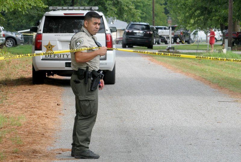 NWA Democrat-Gazette/DAVID GOTTSCHALK A member of the Washington County Sheriff's Office monitors the perimeter Friday at Sonora Acres where an armed man was shot Thursday night after officers were called to a physical domestic disturbance, a Sheriff's Office spokeswoman said. Deputies, assisted by the Springdale Police Department, responded to the disturbance at 11:16 p.m., spokeswoman Kelly Cantrell said.