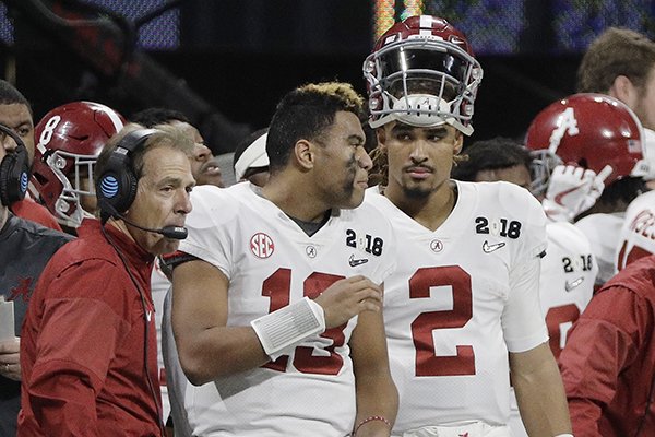 Alabama's Jalen Hurts (2) is seen on the bench with Tua Tagovailoa (13) head coach Nick Saban during the second half of the NCAA college football playoff championship game against Georgia Monday, Jan. 8, 2018, in Atlanta. (AP Photo/David J. Phillip)