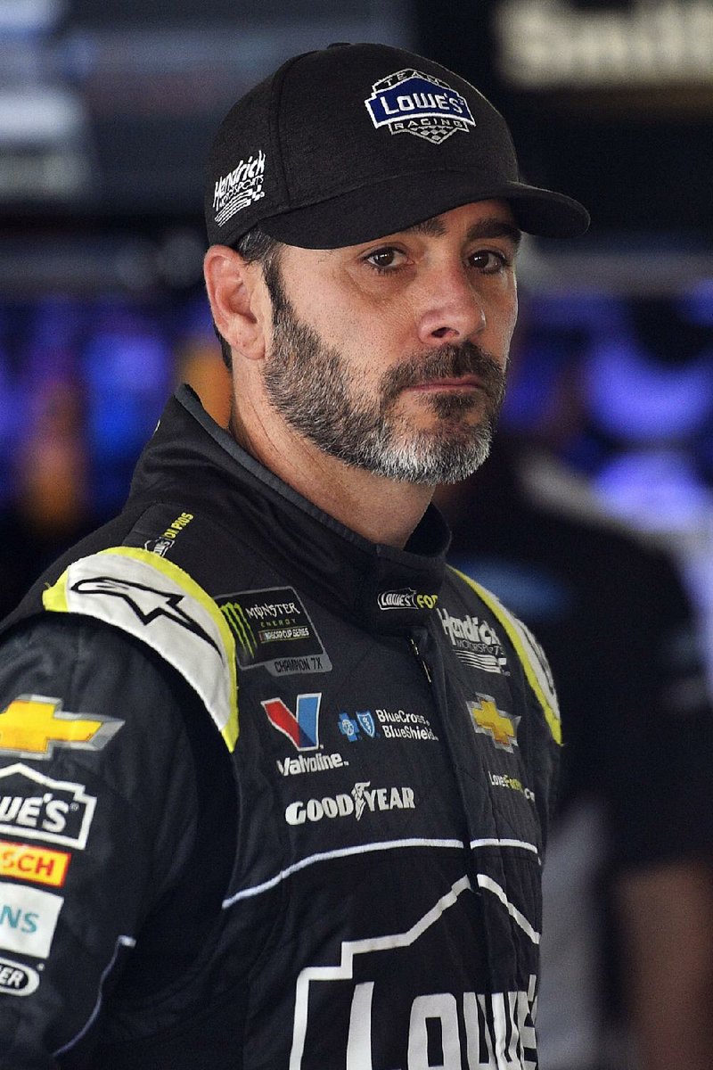 Jimmie Johnson looks out from the garage area during practice for Sunday's NASCAR Cup Series auto race, Saturday, July 28, 2018, in Long Pond, Pa.