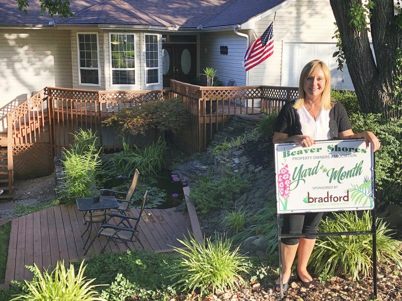 Courtesy photo Jim and Angela Reid are July's Beaver Shores POA Yard of the Month. The Reids moved to Beaver Shores in 2015 and have worked very hard on their yard. They have a beautiful water feature with a rock retaining wall that contains several Koi fish. Angela said she started with six fish, and they have multiplied tremendously. Bradford Yard Living + Landscaping was the sponsor and donated a $25 gift card.