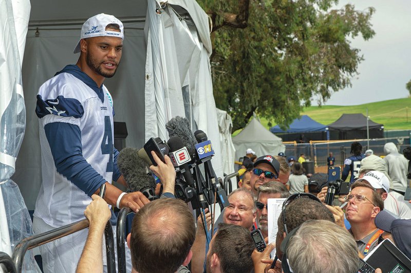 Dallas Cowboys quarterback Dak Prescott takes questions from the media after the morning walk through practice during NFL training camp, Friday, July 27, 2018, in Oxnard, Calif. (AP Photo/Gus Ruelas)