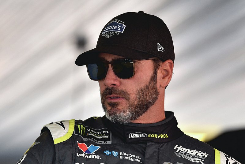 Jimmie Johnson climbs into his car prior to practice for Sunday's NASCAR Cup Series auto race, Saturday, July 28, 2018, in Long Pond, Pa. 