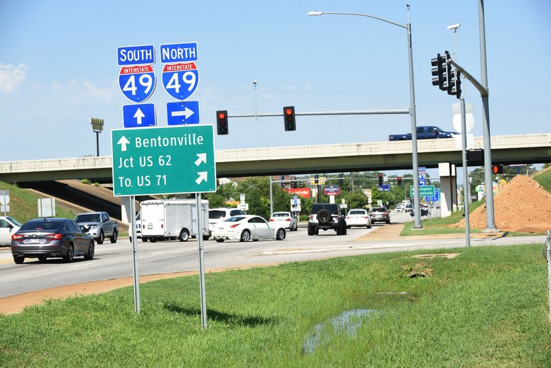 NWA Democrat-Gazette/FLIP PUTTHOFF Traffic moves July 21 at the West Walnut Street and Interstate 49 intersection in Rogers. "I-49 is a real barrier to local traffic, and this is the way to get across the interstate without having to go through those clogged up interchanges," said City Engineer Nathan Becknell.