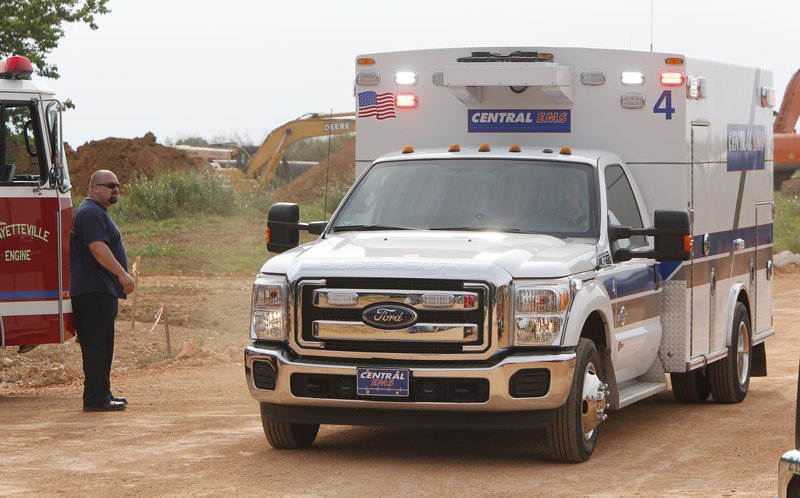 NWA Democrat-Gazette/DAVID GOTTSCHALK An ambulance leaves the scene where city of Fayetteville Firefighters rescued a construction worker trapped in a trench Wednesday, August 31, 2016, near the intersection of West Persimmon Street and 54th Avenue in Fayetteville. A statement from the Fire Department said the man was buried in four to six feet of dirt up to his chest and neck area. Firefighters secured the area and then dug the man out by hand with shovels. The man was alert and conscious and transferred to Washington Regional Hospital in Fayetteville. No other information was available at the time concerning injuries.