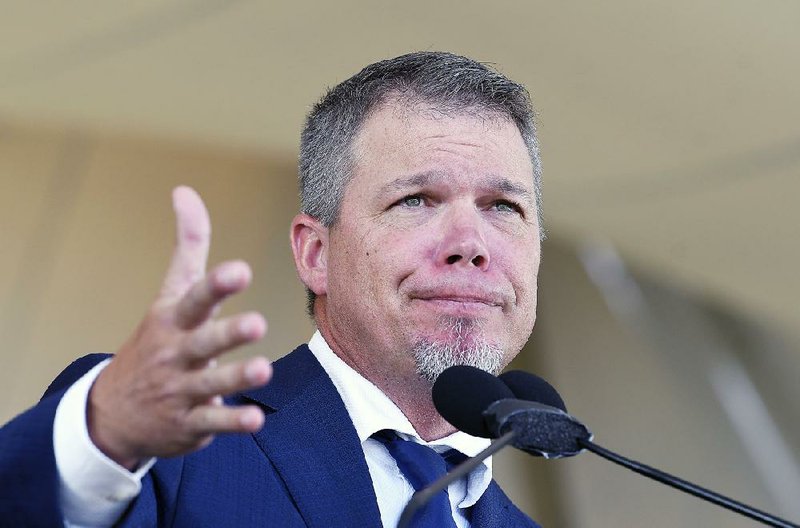 Chipper Jones, one of six players inducted into the MLB Hall of Fame on Sunday, speaks during the induction ceremony at the Clark Sports Center in Cooperstown, N.Y. Jones kept his emotions in check as a crowd estimated at 50,000 took in the festivities.