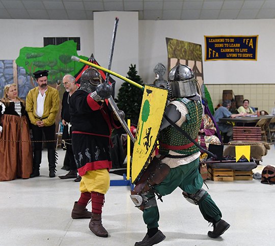 The Sentinel-Record/Grace Brown BATTLE ROYAL: Alex Hooper, of Little Rock, left, and Kellen Durio, of Louisiana, participate in a tournament-style sword fight at the feast of St. Hubertus hosted by the Society for Creative Anachronism at Camp Couchdale on Saturday.