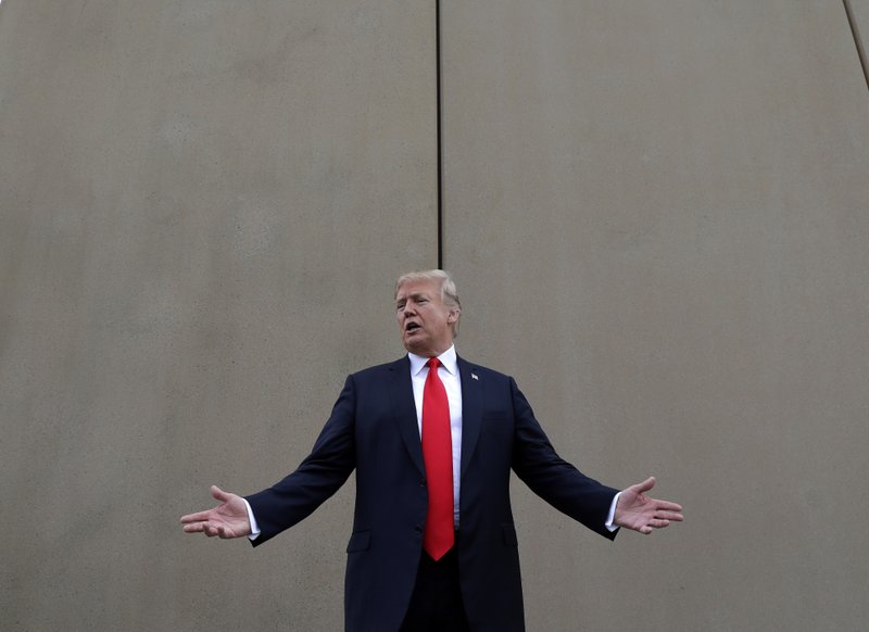 FILE - In this March 13, 2018, file photo, President Donald Trump speaks during a tour as he reviews border wall prototypes in San Diego. Trump said Sunday, July 29, 2018, that he would consider shutting down the government if Democrats refuse to vote for his immigration proposals, including building a wall along the U.S.-Mexico border. (AP Photo/Evan Vucci, File)