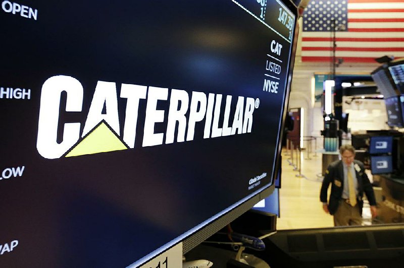 Heavy-equipment company Caterpillar, whose logo appears above a trading post at the New York Stock Exchange on Monday, raised its earnings forecast for the year.