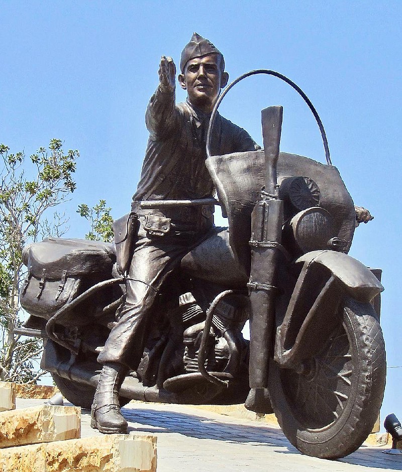 A statue of Fort Smith native Gen. William O. Darby on a Harley-Davidson motorcycle designed for military use adorns Cisterna Plaza in downtown Fort Smith.