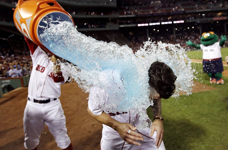Boston Red Sox’s Blake Swihart (right) is doused with sports drink Monday after his walk-off RBI double off Philadelphia Phillies relief pitcher Luis Garcia.