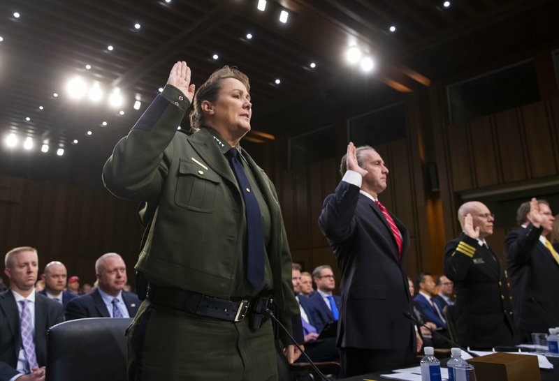 From left, Customs and Border Protection U.S. Border Patrol Acting Chief Carla Provost, U.S. Immigration and Customs Enforcement Executive Associate Director of Enforcement And Removal Operations Matthew Albence, Federal Health Coordinating Official for the 2018 UAC Reunification Effort Cmdr. Dr Jonathan White, and Executive Office for Immigration Review Director James McHenry III are sworn in to testify as the Senate Judiciary Committee holds a hearing on the Trump administration's policies on immigration enforcement and family reunification efforts on Capitol Hill in Washington on Tuesday, July 31, 2018.