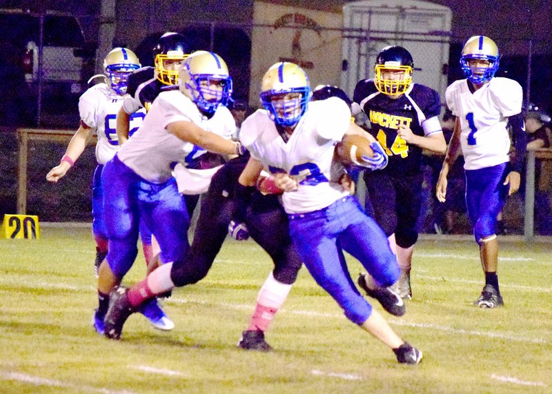 Westside Eagle Observer/MIKE ECKELS A Bulldog running back breaks through a swarm of Hornets with help from a few teammates during the Decatur-Hackett football contest in Hackett Oct. 6, 2017. James Ortiz will take over as head football coach this season as the Bulldogs transition from eleven-man to eight-man football in September.