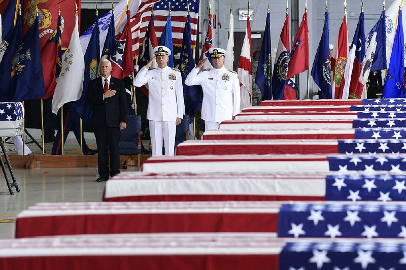 FILE - Vice President Mike Pence; Adm. Phil Davidson (center), head of the U.S. Indo-Pacific Command; and Rear Adm. Jon Kreitz, deputy director of the POW/MIA Accounting Agency, take part in a ceremony Aug. 1, 2018 at Pearl Harbor, Hawaii, as what are believed to be the remains of more than 50 servicemen killed in the Korean War arrive from South Korea for analysis and identification.