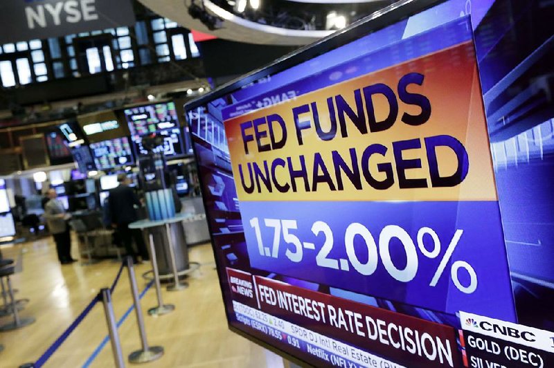 A screen on the floor of the New York Stock Exchange shows the Federal Reserve’s rate decision Wednesday.