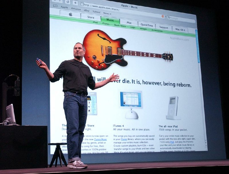 The late Apple Computer Inc. chief executive Steve Jobs speaks during Apple’s April 2003 launch of its online Music Store and iPod in San Francisco. Apple stock surged this week in anticipation of September’s release of the next generation of iPhone.