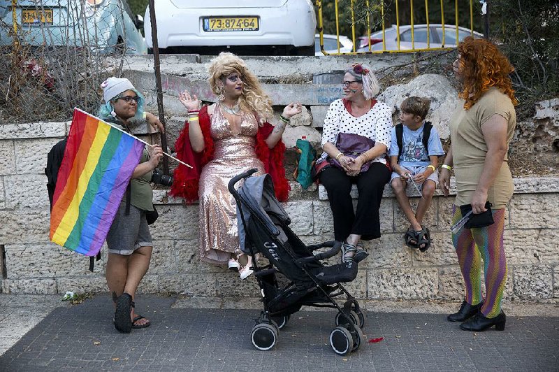 People take part in the annual Gay Pride parade Thursday that drew about 15,000 marchers in Jerusalem.