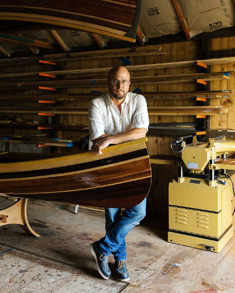 Trent Preszler, the chief executive of Bedell Cellars winery, leans on the 18-foot-long wooden canoe he is building during a summer sabbatical in Mattituck, N.Y.
