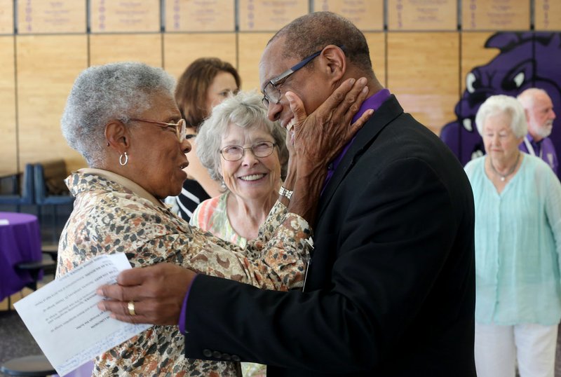 Peggy Taylor Lewis (left) is greeted Thursday by John L Colbert, superintendent of Fayetteville Public Schools, during the Hall of Honor luncheon hosted by the Fayetteville Public Education Foundation at Fayetteville High School. The 2018 inductees are James Hunt, George Spencer, Mary “Faye” Jones and Lewis.