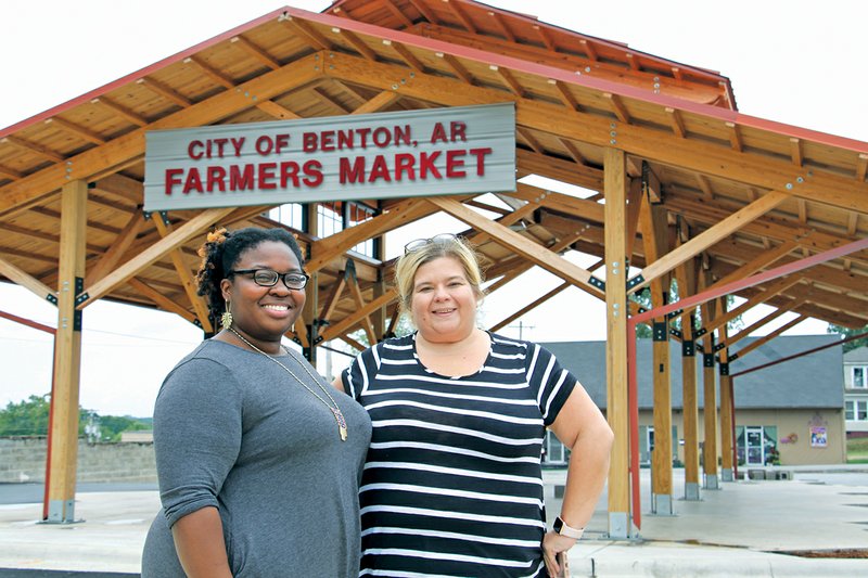 Sarita Robinson, left, and Becca Hudson stand in front of the Farmers Market in downtown Benton. Robinson and Hudson are organizing a block party for Saturday with the proceeds benefiting ALS Association Arkansas Chapter. 