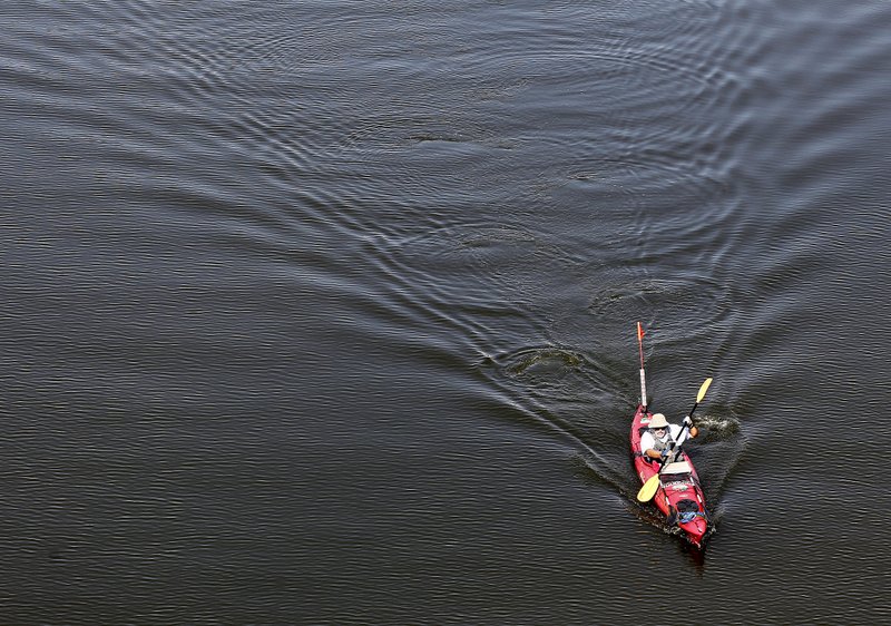 Hannes Zacharias kayaks along the Arkansas River on Thursday in central Arkansas.