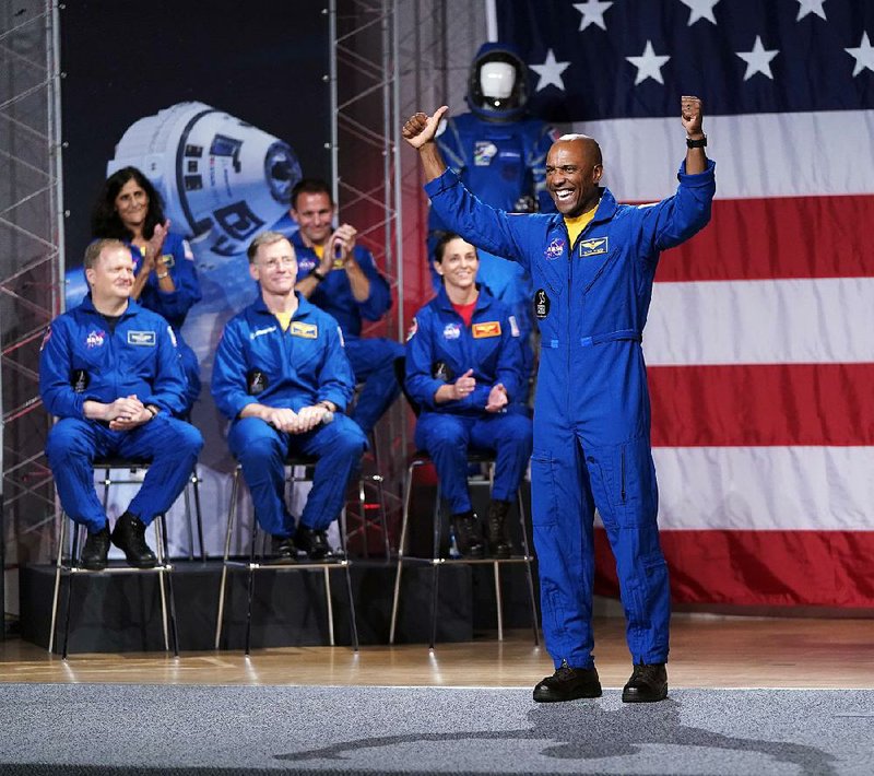 Victor Glover stands as he is introduced Friday in Houston along with other astronauts named by NASA as crew members for the flight tests and missions of the first manned commercial capsules set to go into orbit next year.